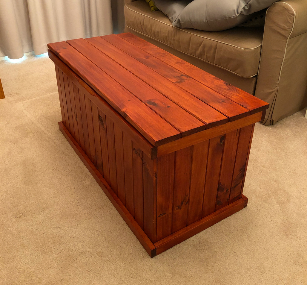 Timber blanket chest in stained pine with tongue and groove panelling