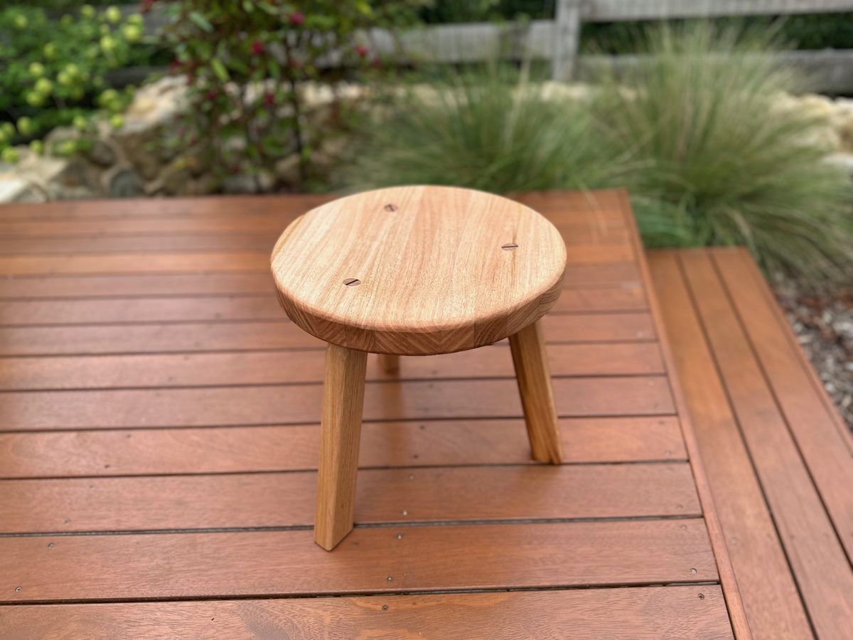 Three-legged stool in Victorian ash with hand-turned seat